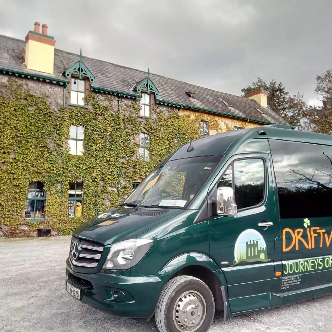 Driftwood tours Drifter tour vehicle outside a leafy building in Ireland
