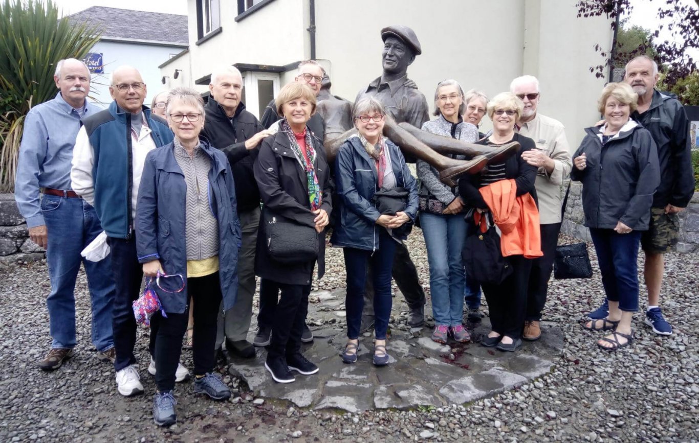 Tour group at the Quiet Man statue in Cong, Ireland