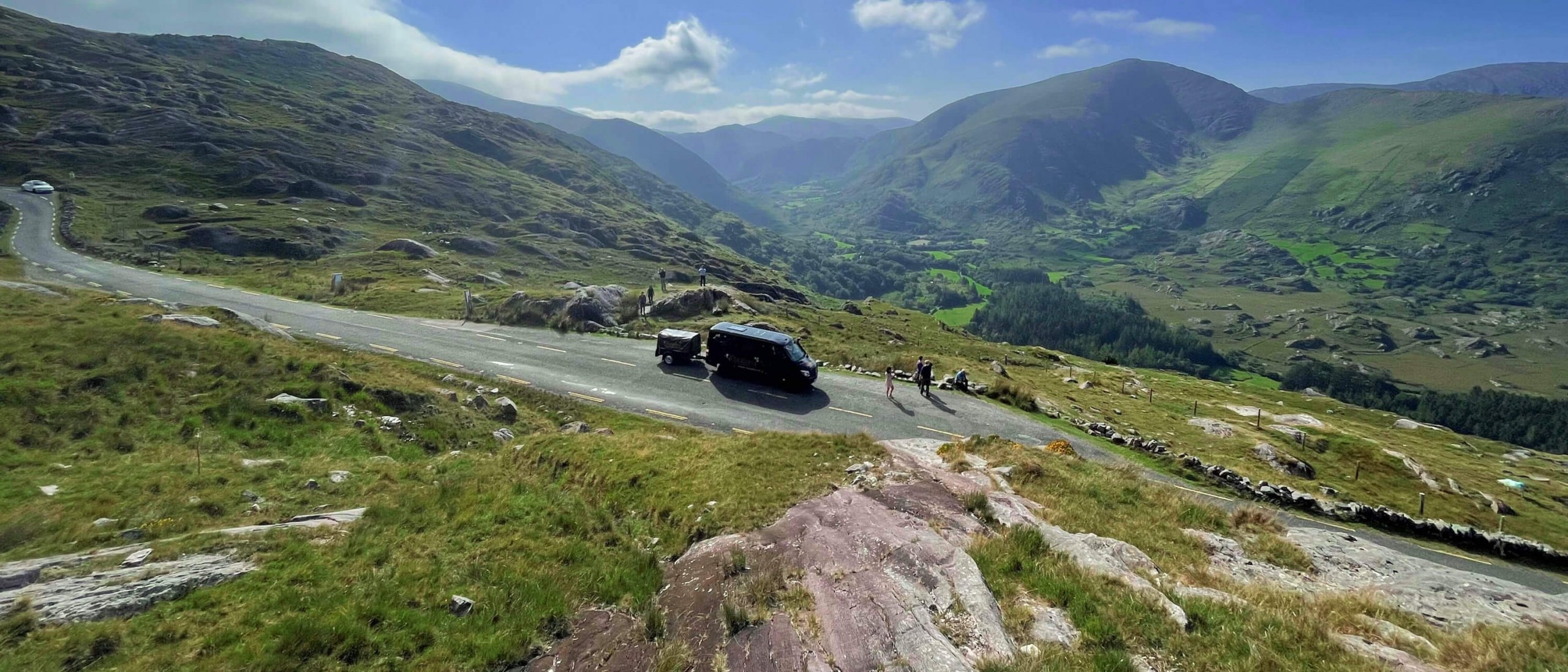 Ireland tour vehicle with guests in scenic landscape in Kerry