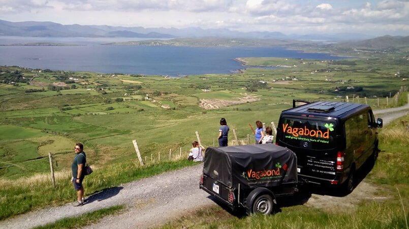 A VagaTron tour vehicle parked up at a scenic spot on the Beara peninsula in Ireland with passengers