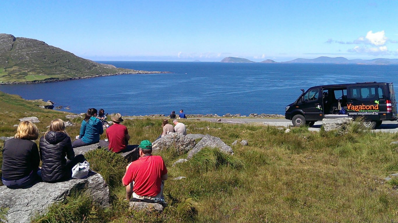 Vagabond Tour group picnic in scenic spot by the ocean in Ireland