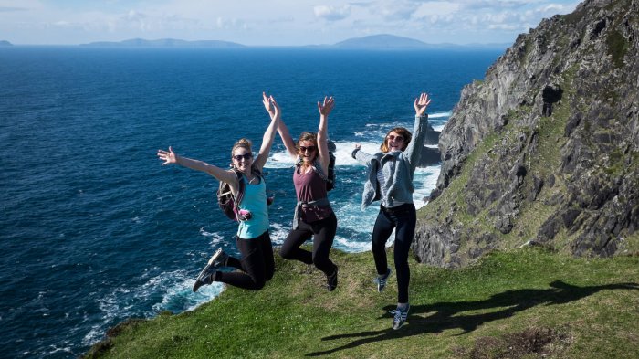 Three Vagabond passengers jump for joy on Bray Head in Kerry